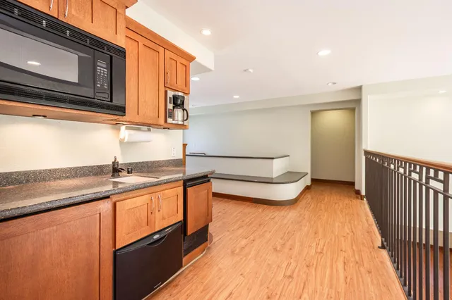 a spacious bedroom with a bed and a flat screen tv