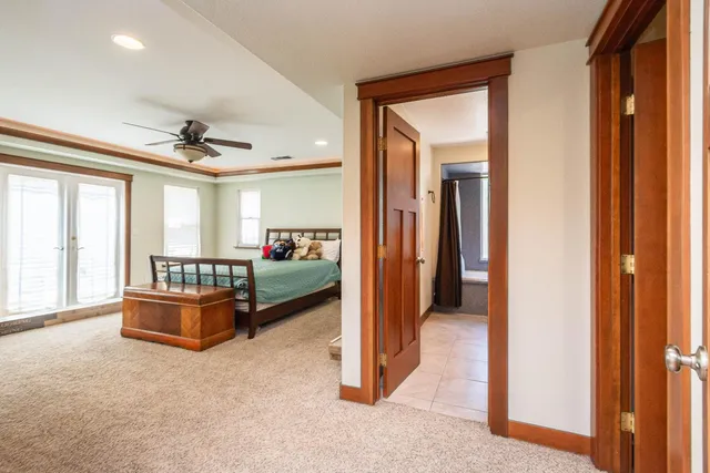 a spacious bedroom with a bed and a fireplace