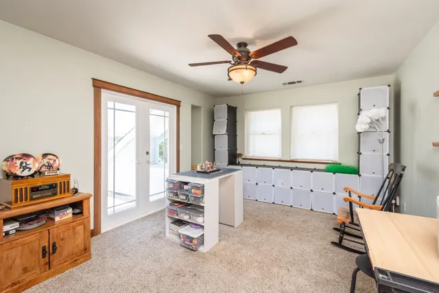 a view of a patio with table and chairs and potted plants