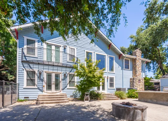 a front view of a house with a garden