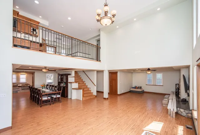 a kitchen with stainless steel appliances granite countertop a sink a stove and a wooden floors