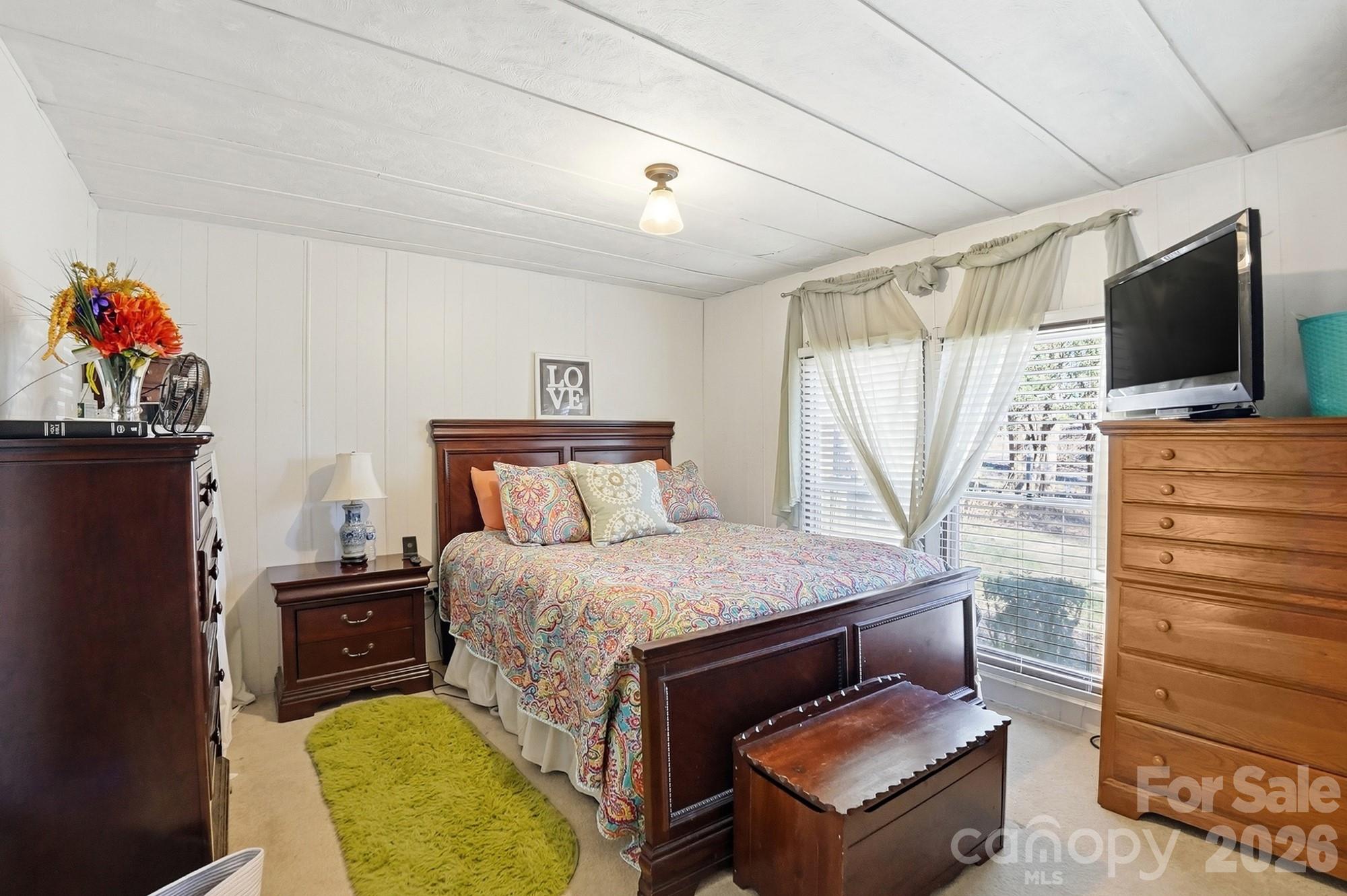 343 Carr Road Dallas, NC 28034 - Photo 16 of 22 a bedroom with a bed and flat screen tv