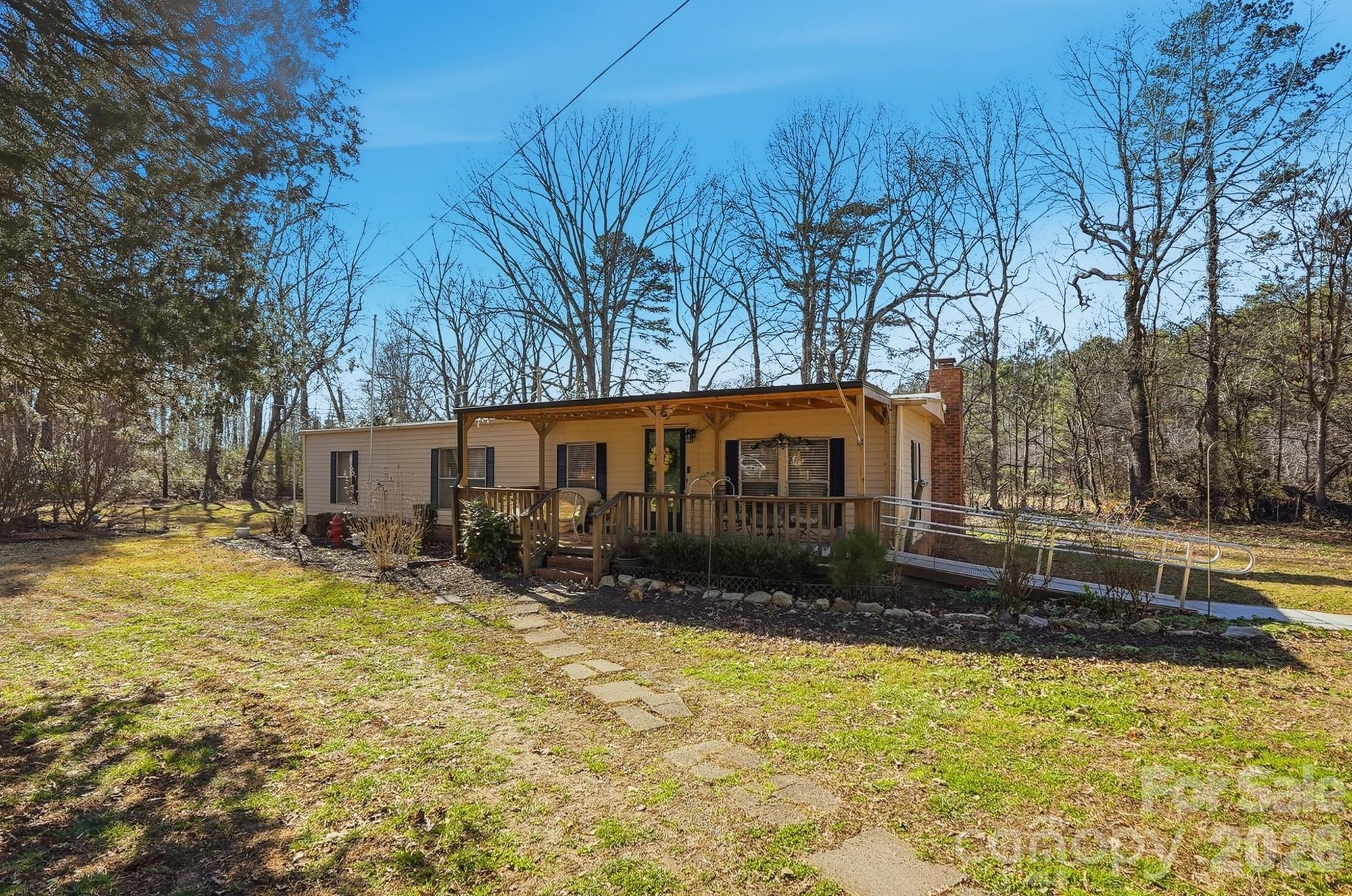 343 Carr Road Dallas, NC 28034 - Photo 3 of 22 a view of a house with a yard covered with snow in the outdoor space