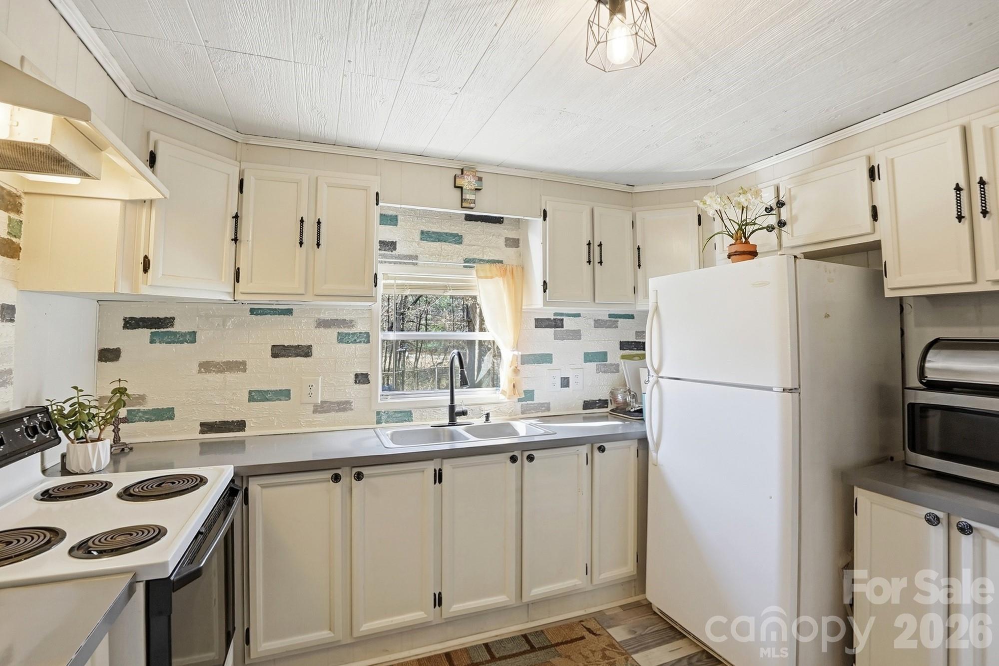 343 Carr Road Dallas, NC 28034 - Photo 8 of 22 a kitchen with kitchen island a sink stove and refrigerator