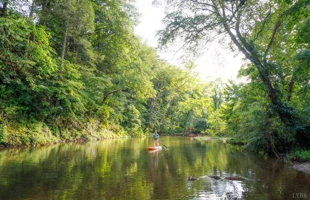 a backyard of a house with wooden floor and outdoor seating