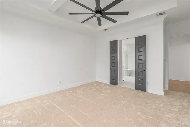 an empty room with closet and fan