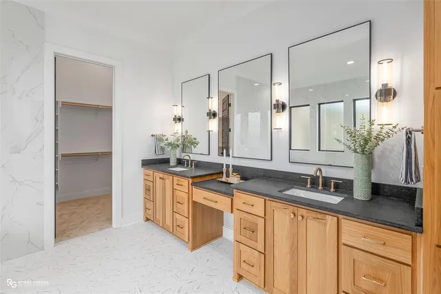 a bathroom with a granite countertop sink and a mirror
