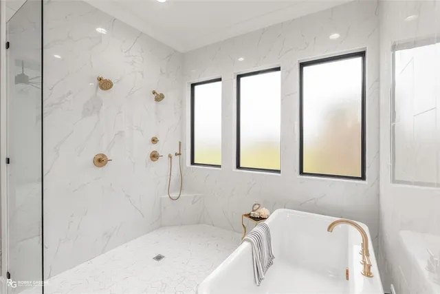 a bathroom with a tub shower and sink