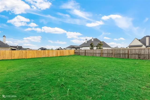 a view of a house with a big yard