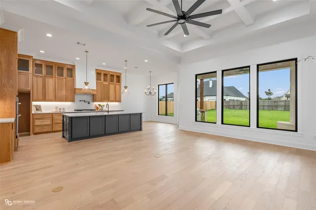 a living room with stainless steel appliances kitchen island granite countertop a refrigerator and a view of living room