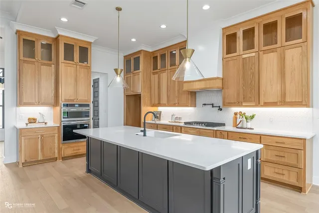 a kitchen that has a sink a stove and a refrigerator