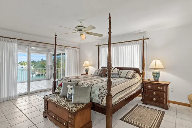 a bed room with a bed window and a chandelier