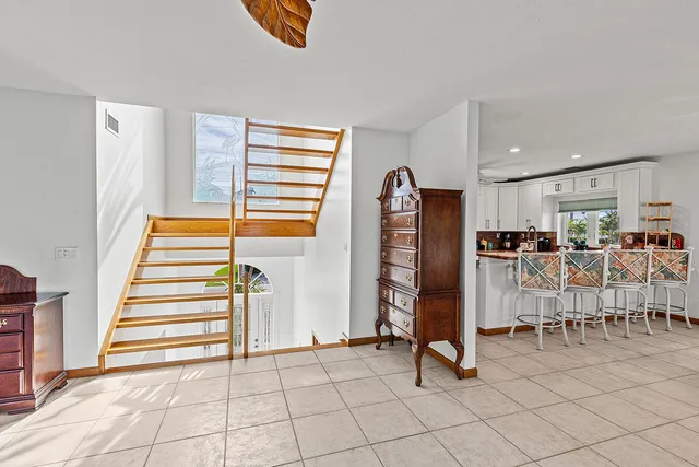 a view of a livingroom with furniture and staircase
