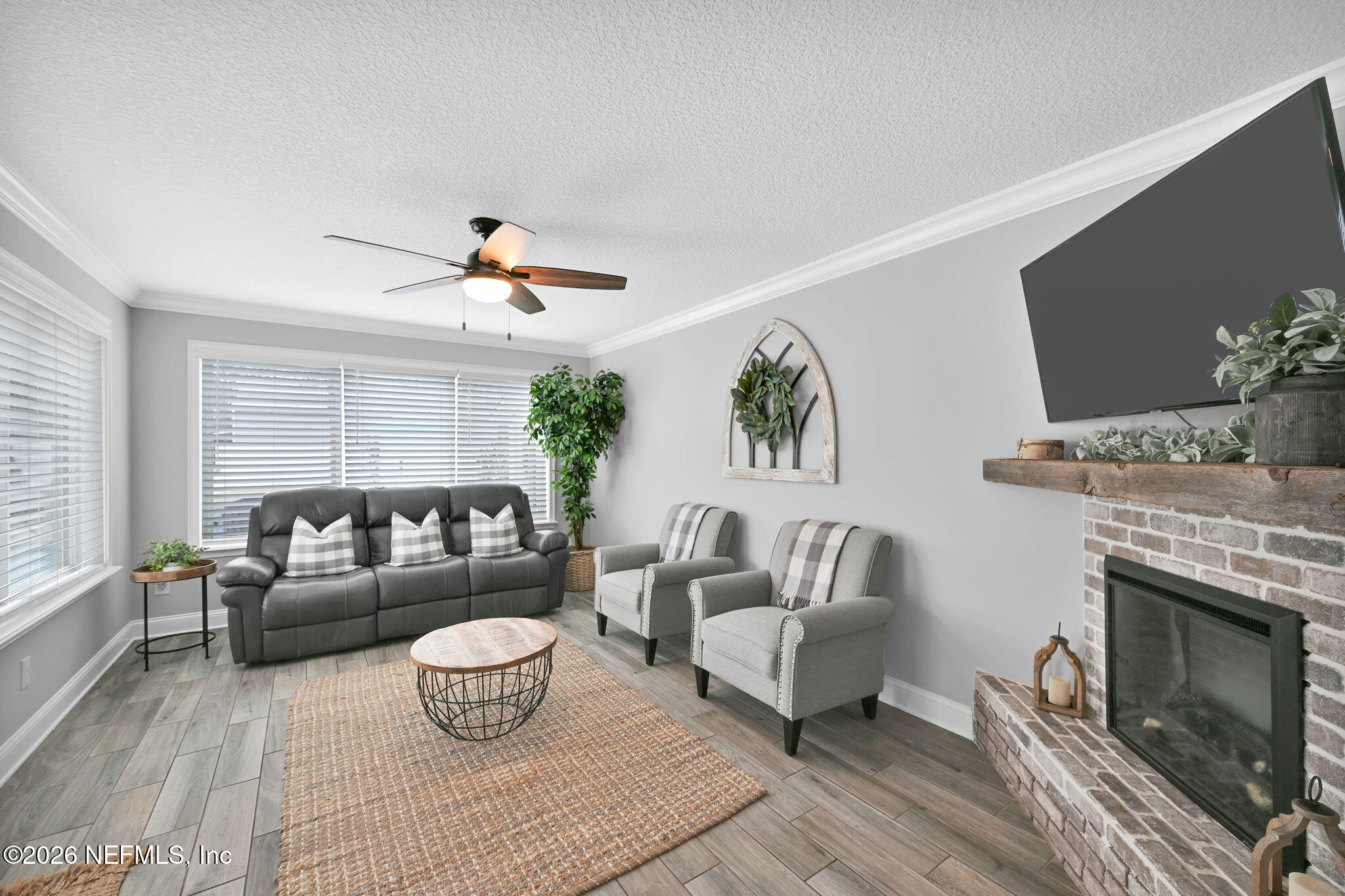 34446 Mitigation Trail Callahan, FL 32011 - Photo 27 of 84 a living room with furniture a fireplace and a chandelier