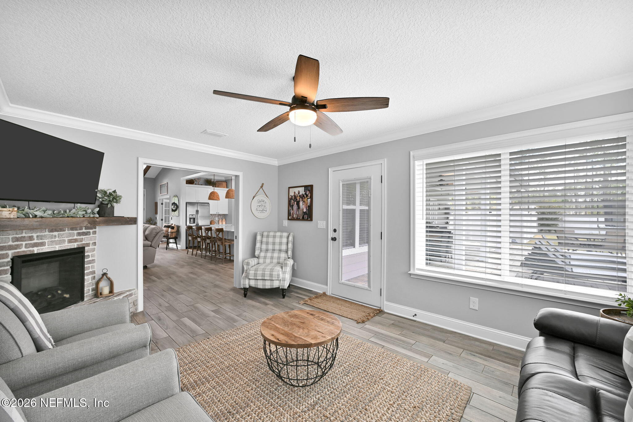 34446 Mitigation Trail Callahan, FL 32011 - Photo 28 of 84 a living room with furniture a fireplace and a flat screen tv