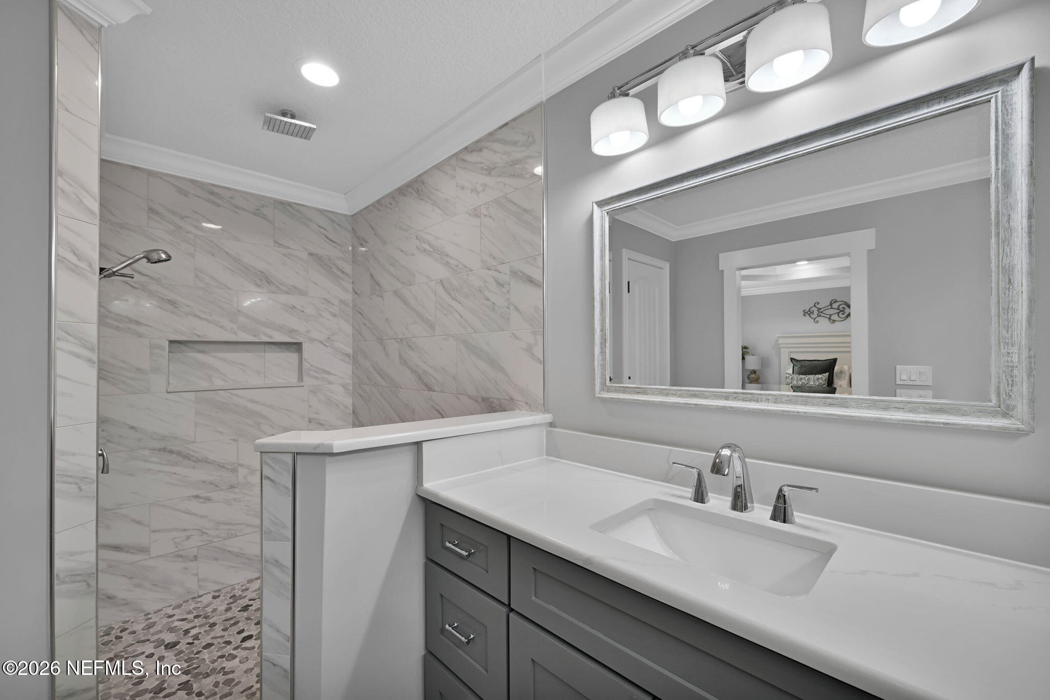 34446 Mitigation Trail Callahan, FL 32011 - Photo 33 of 84 a bathroom with a granite countertop sink a large mirror and vanity