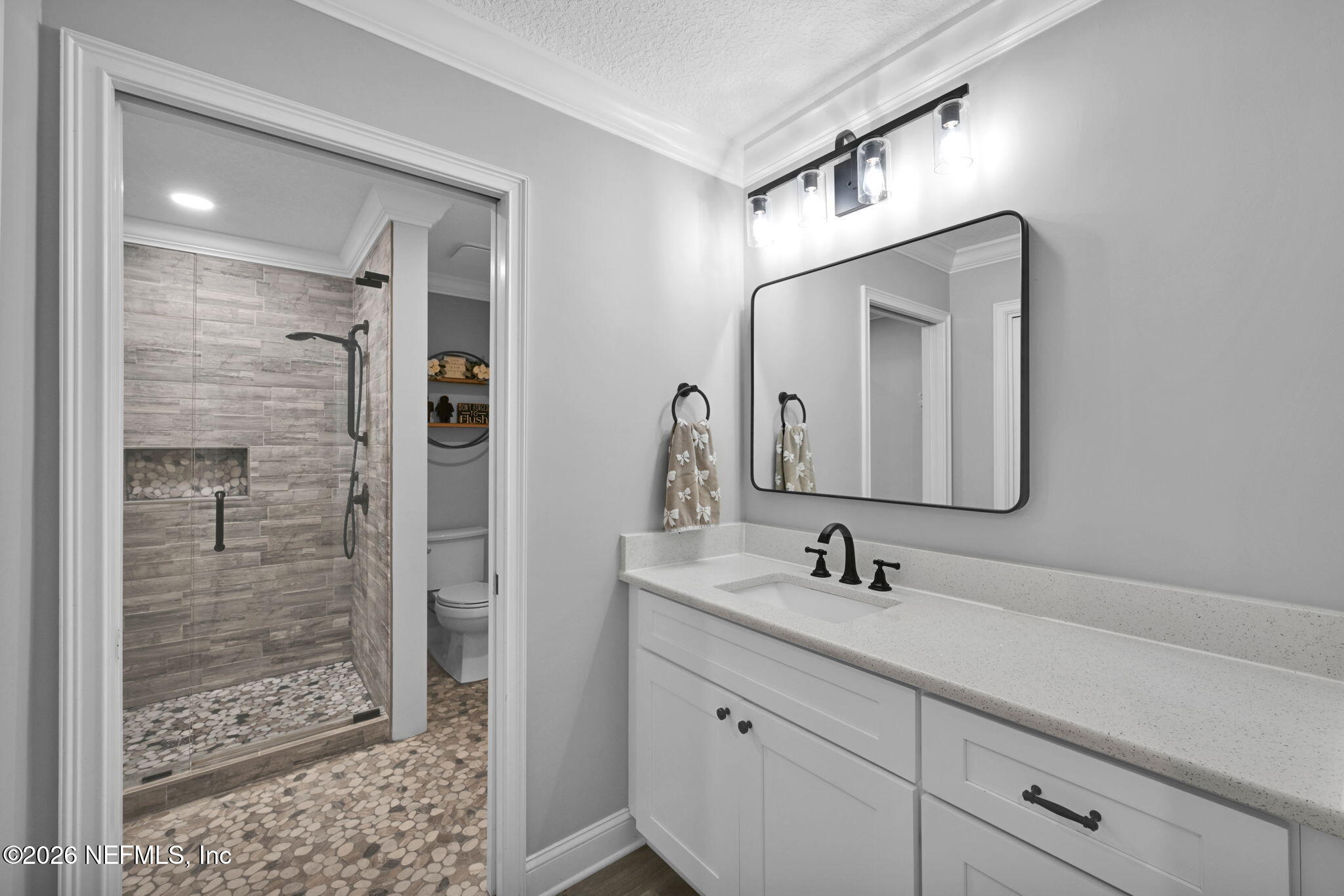 34446 Mitigation Trail Callahan, FL 32011 - Photo 35 of 84 a bathroom with a shower sink and mirror