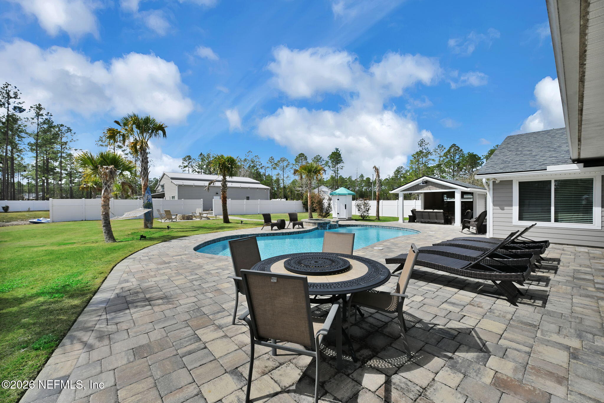 34446 Mitigation Trail Callahan, FL 32011 - Photo 40 of 84 a view of a house with backyard sitting area and fire pit
