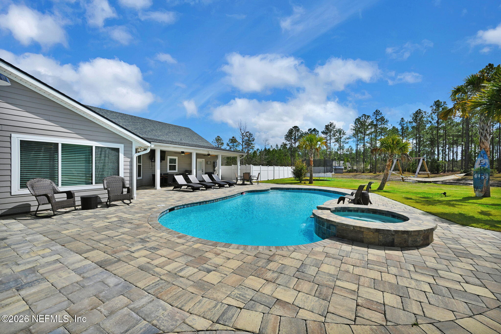 34446 Mitigation Trail Callahan, FL 32011 - Photo 45 of 84 a view of a house with swimming pool and sitting area