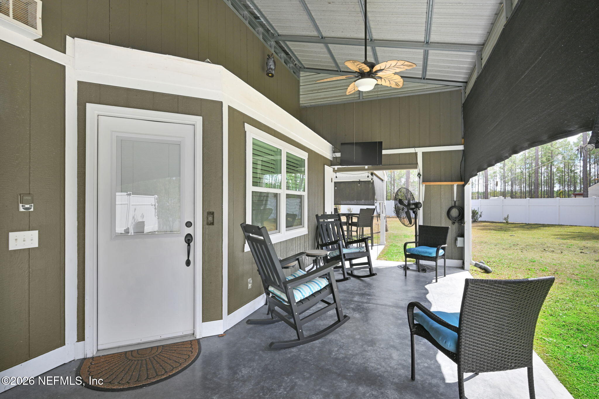 34446 Mitigation Trail Callahan, FL 32011 - Photo 56 of 84 a living room with patio furniture and a chandelier