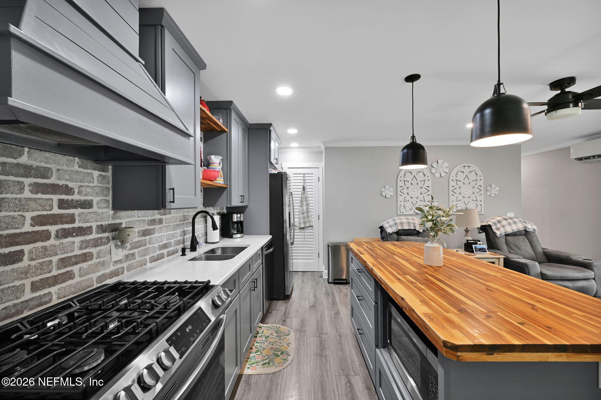34446 Mitigation Trail Callahan, FL 32011 - Photo 59 of 84 a kitchen with stainless steel appliances granite countertop a sink stove and cabinets