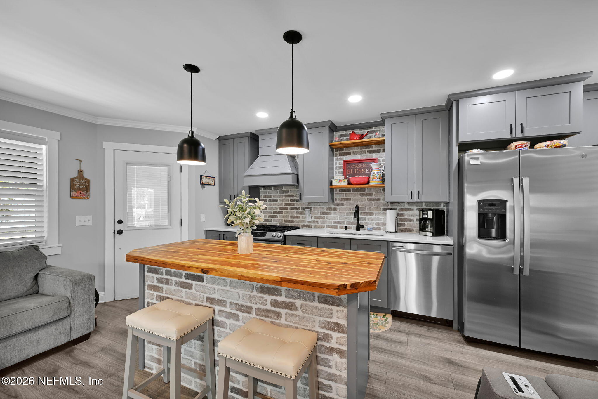 34446 Mitigation Trail Callahan, FL 32011 - Photo 61 of 84 a kitchen with stainless steel appliances granite countertop a sink refrigerator and cabinets