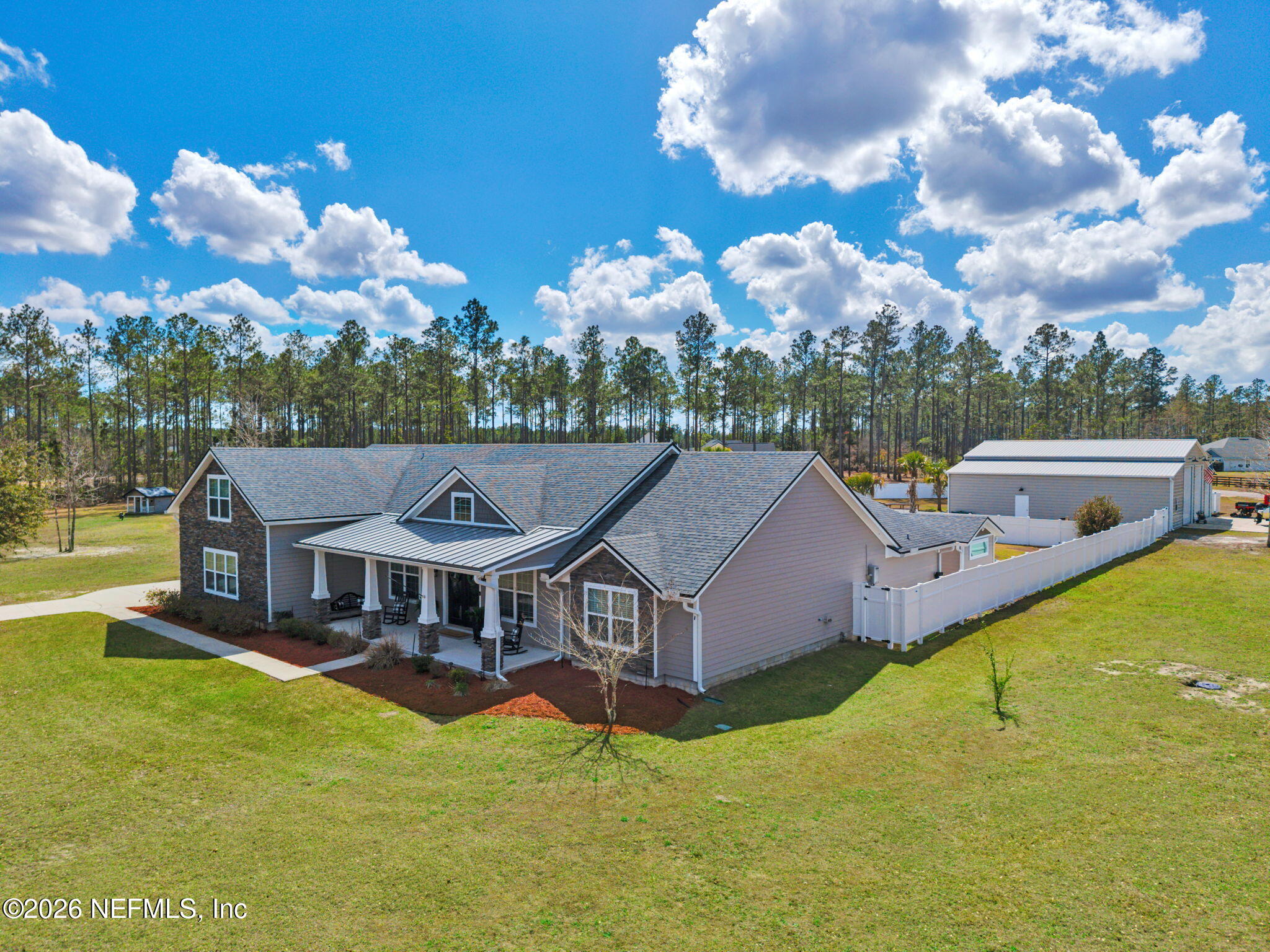 34446 Mitigation Trail Callahan, FL 32011 - Photo 69 of 84 a aerial view of a house with swimming pool and a yard