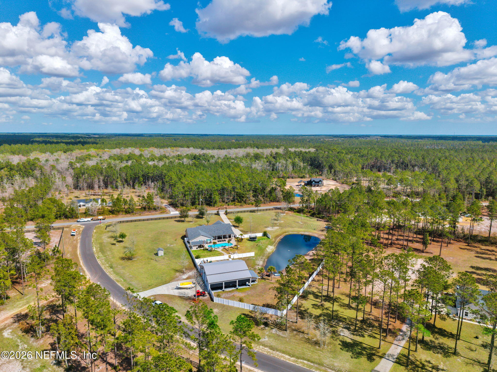34446 Mitigation Trail Callahan, FL 32011 - Photo 75 of 84 a view of a lake with couches in the patio