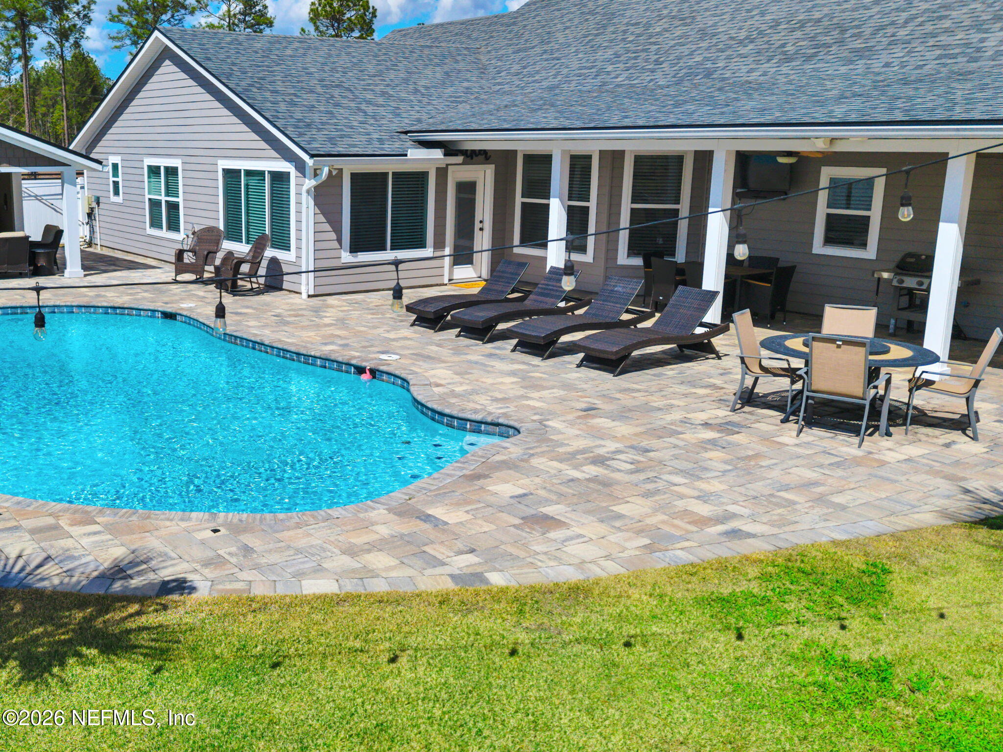 34446 Mitigation Trail Callahan, FL 32011 - Photo 83 of 84 a view of a house with swimming pool and sitting area
