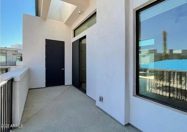 a view of a hallway with furniture and a window