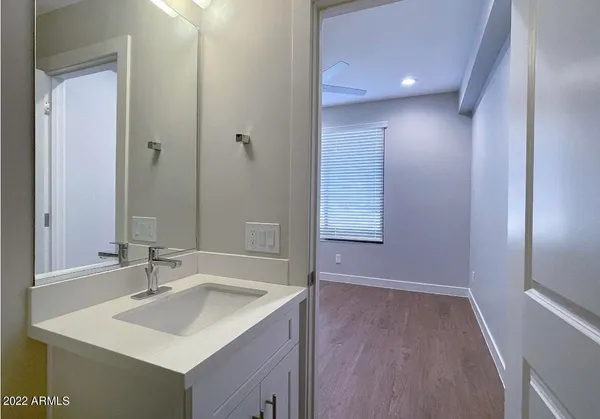 an empty room with closet and wooden floor