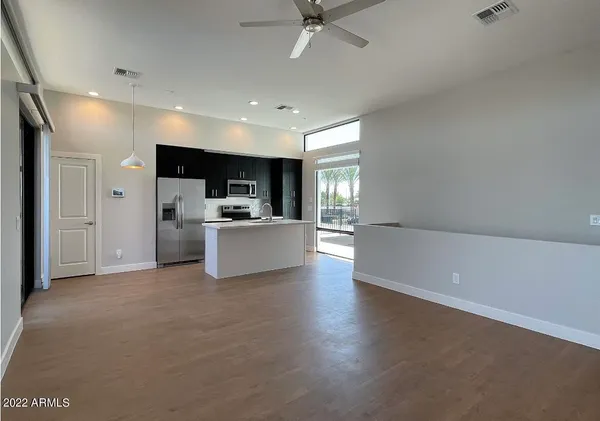 a view of a kitchen with a sink and a refrigerator