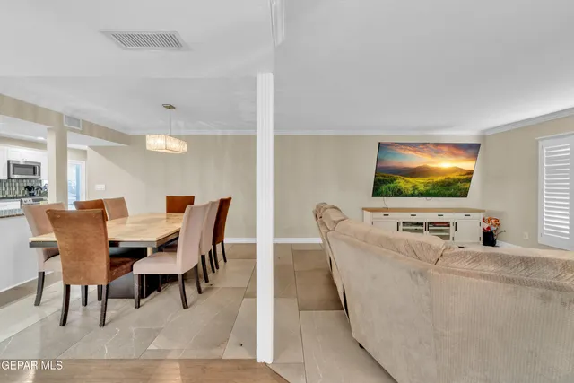 a living room with lots of furniture and a book shelf