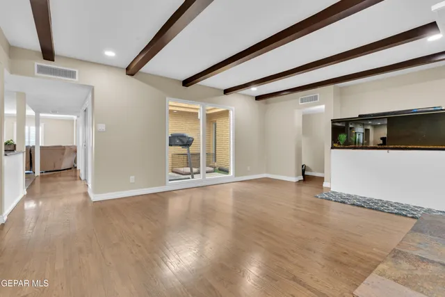 a kitchen with a white cabinets and chairs in it