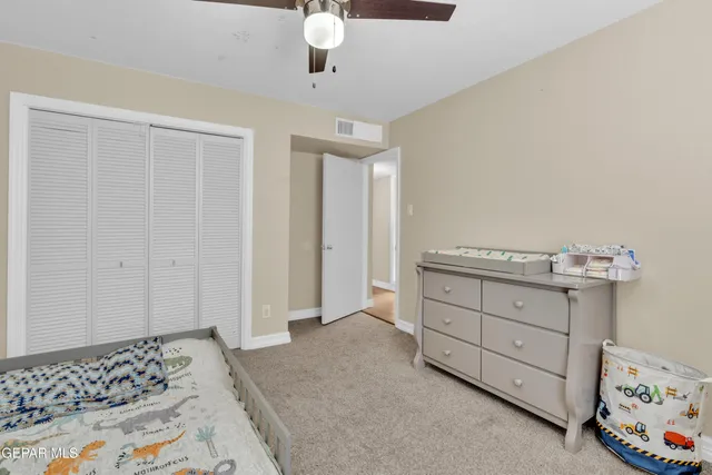 a bedroom with a bed and a flat tv screen