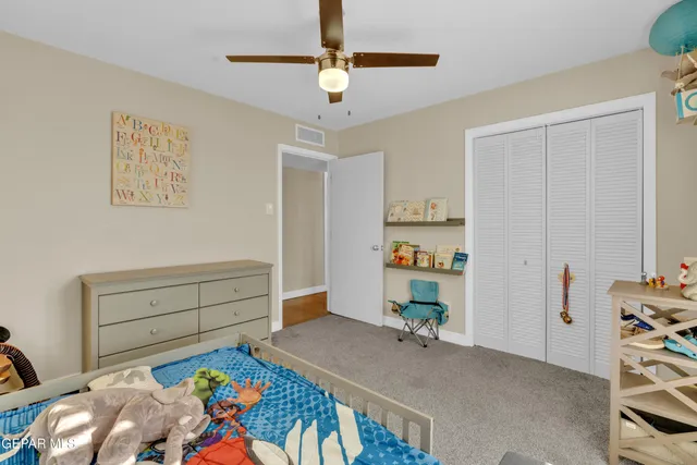 a bedroom with a bed and a dresser