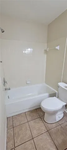 a bathroom with a toilet and a bathtub