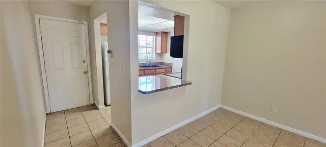 an entryway and a hallway with wooden floor
