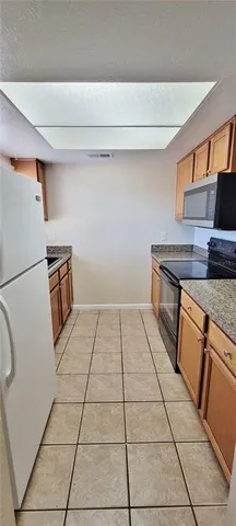 a kitchen with a stove top oven and cabinets