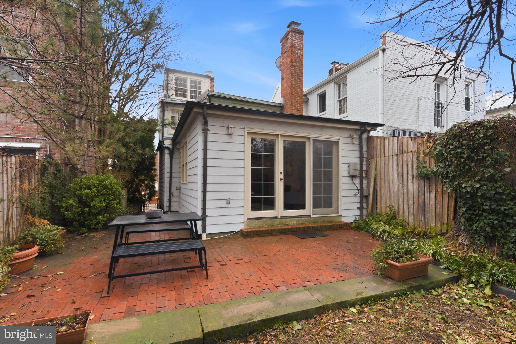 2719 Dumbarton Street Northwest Washington, DC 20007 - Photo 24 of 32 a bench sitting in front of a house