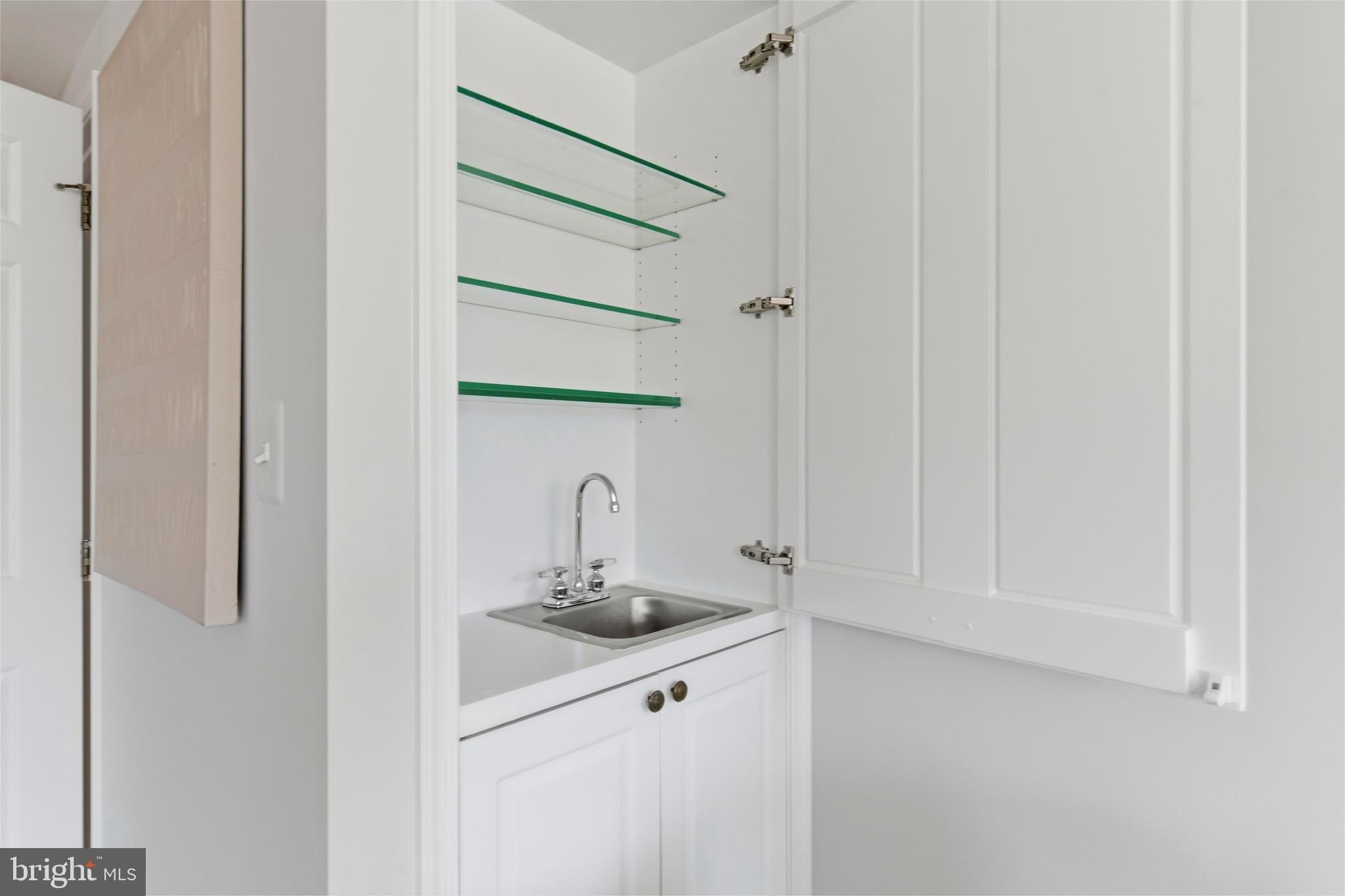 2719 Dumbarton Street Northwest Washington, DC 20007 - Photo 29 of 32 a bathroom with a sink and mirror