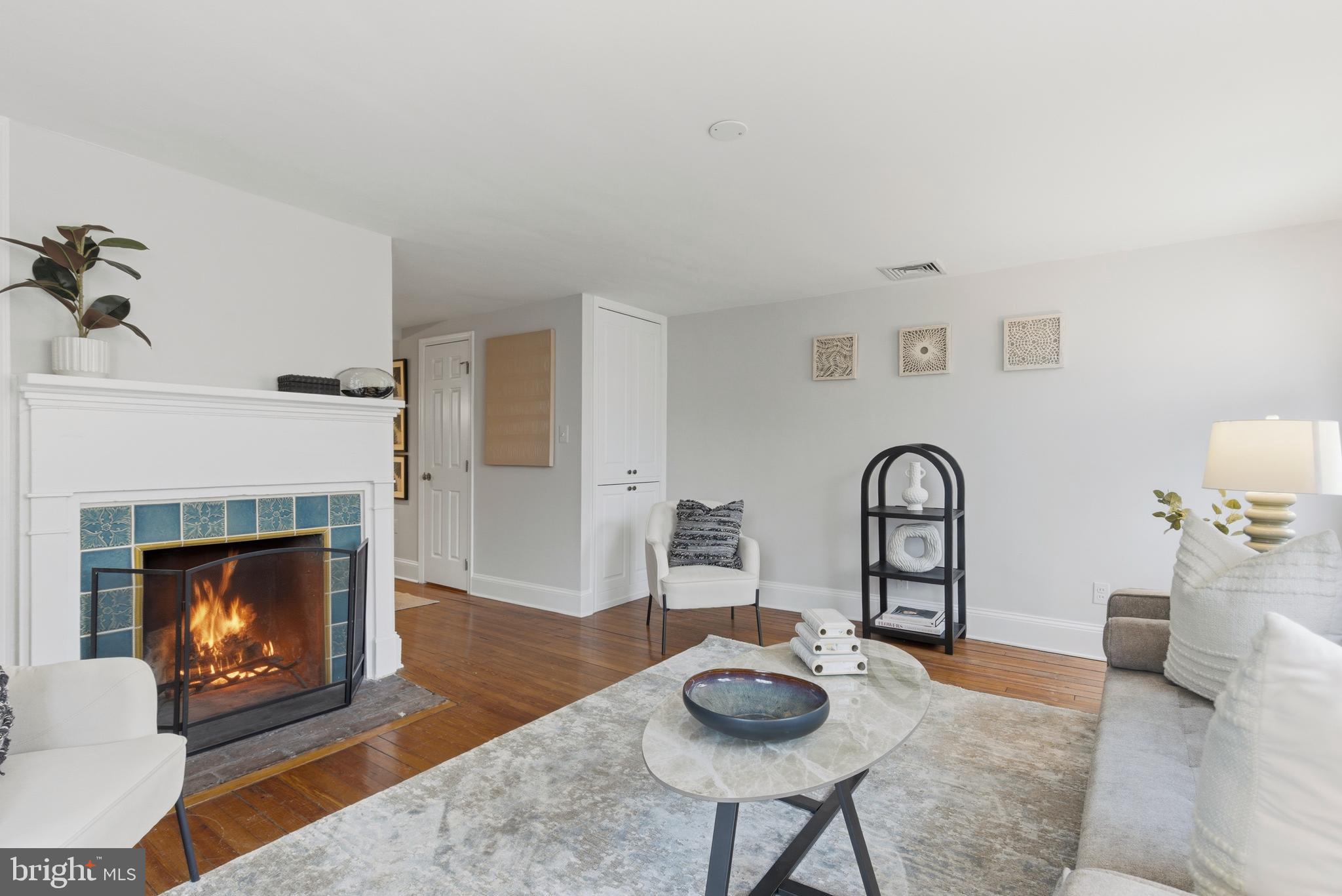 2719 Dumbarton Street Northwest Washington, DC 20007 - Photo 4 of 32 a living room with furniture and a fireplace