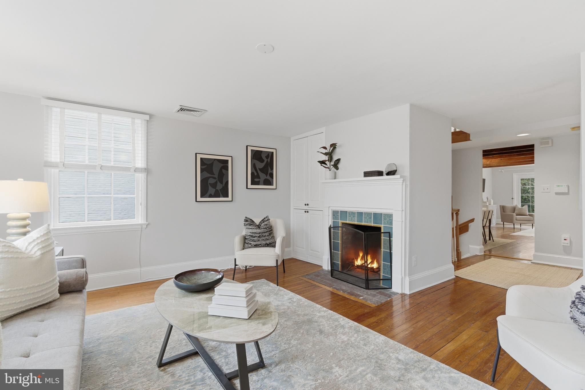 2719 Dumbarton Street Northwest Washington, DC 20007 - Photo 5 of 32 a living room with furniture and a fireplace