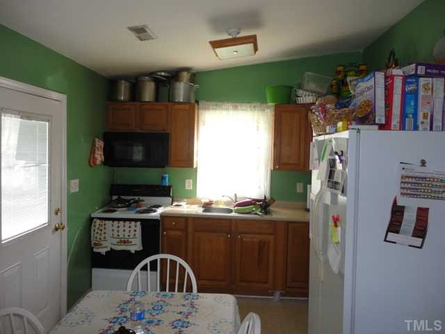 2649 Hodge Road Raleigh, NC 27610 - Photo 2 of 9 a kitchen with stainless steel appliances granite countertop a stove a sink and a refrigerator