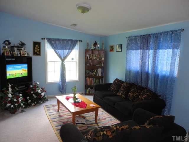 2649 Hodge Road Raleigh, NC 27610 - Photo 3 of 9 a living room with furniture and a flat screen tv