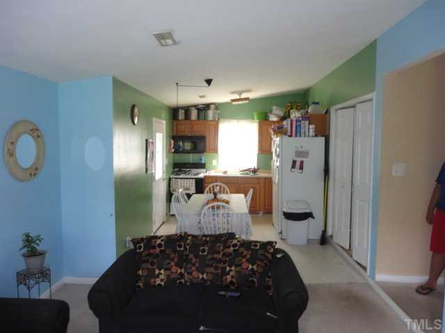 2649 Hodge Road Raleigh, NC 27610 - Photo 4 of 9 a bedroom with a large bed and a chandelier
