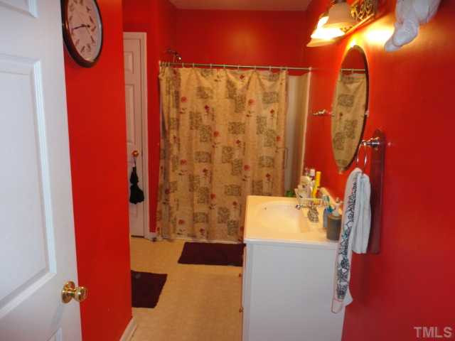 2649 Hodge Road Raleigh, NC 27610 - Photo 5 of 9 a bathroom with a sink and a mirror