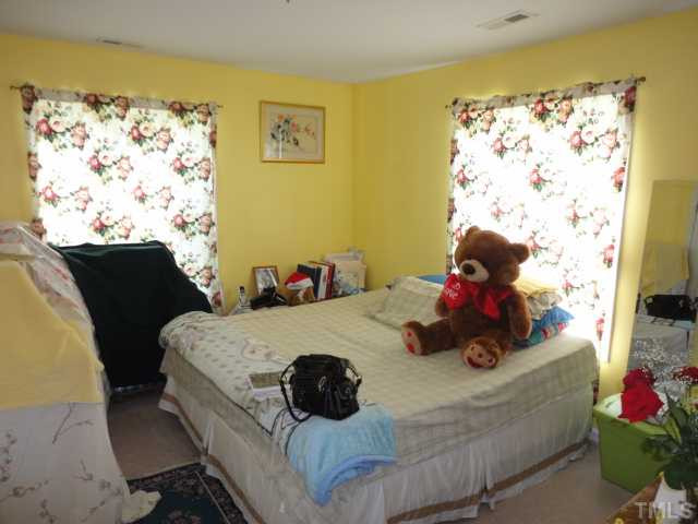 2649 Hodge Road Raleigh, NC 27610 - Photo 7 of 9 a bed sitting in a bedroom next to a window