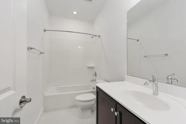 a bathroom with a sink vanity and a mirror
