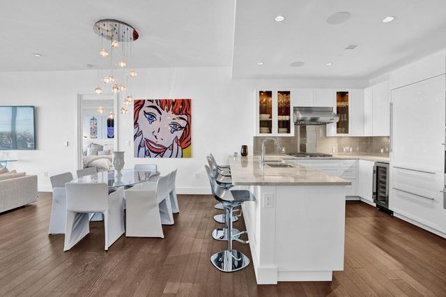a living room with granite countertop furniture and wooden floor